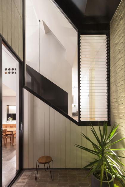 Unfurled House courtyard view to stair and bathroom