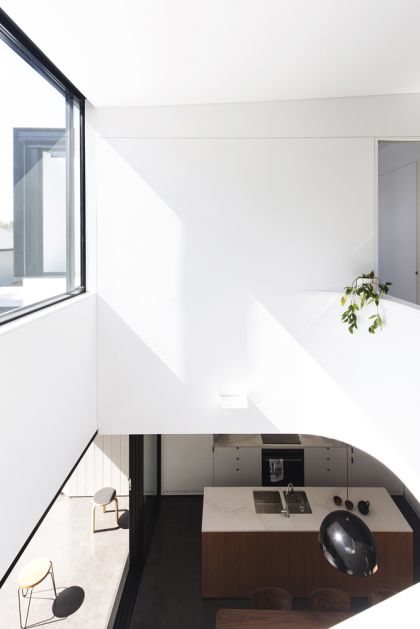 Unfurled House interior view through void to kitchen