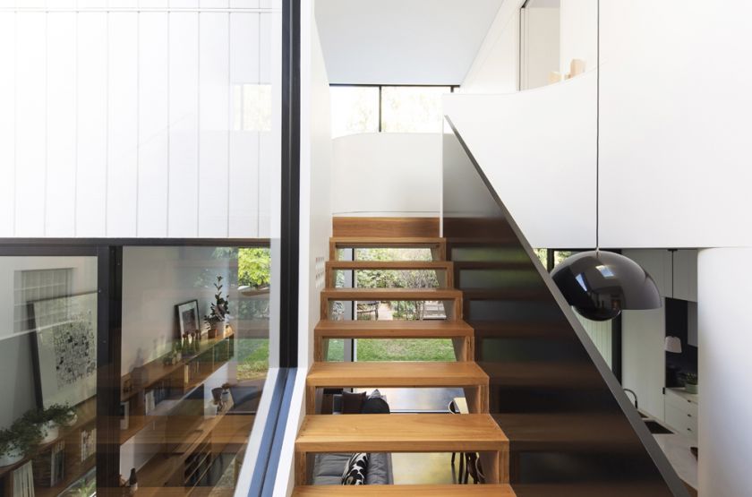 Unfurled House interior detail view of stair to living and first floor spaces beyond