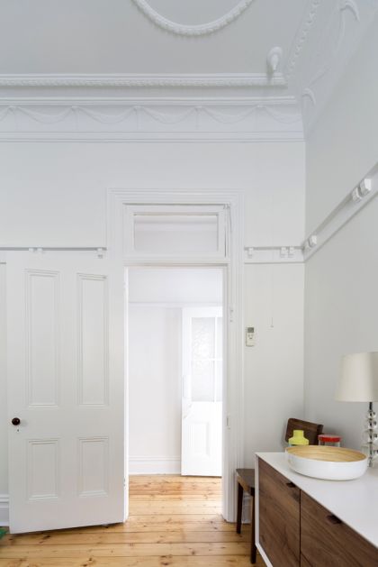 Unfurled House interior view of refurbished original living room and hall beyond