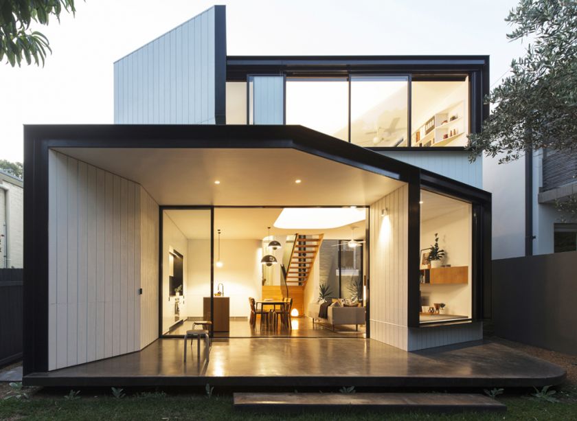 Unfurled House rear exterior view at dusk