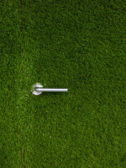 Wintons Teak Showroom door handle in turf wall